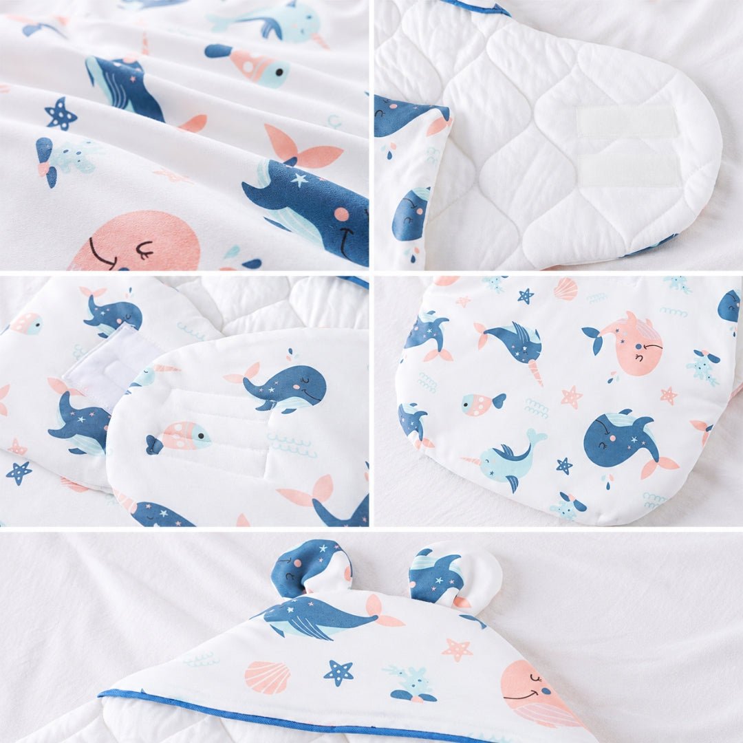 Détails du nid d'ange garçon : imprimé baleines, intérieur matelassé, scratch et oreilles