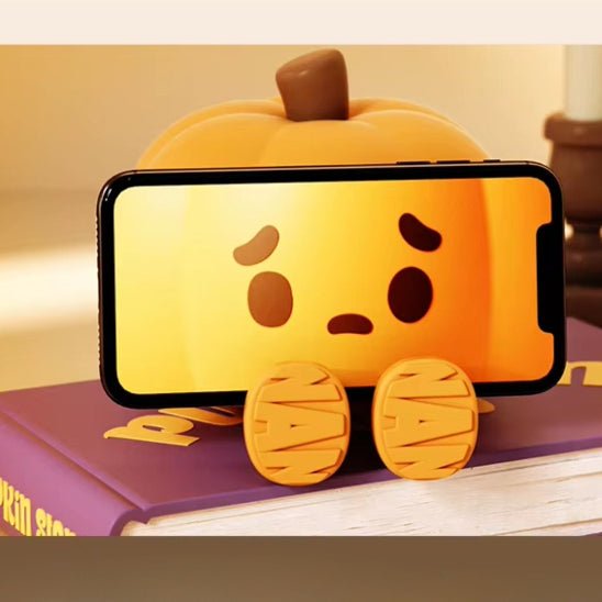 Veilleuse bébé citrouille servant de support pour téléphone