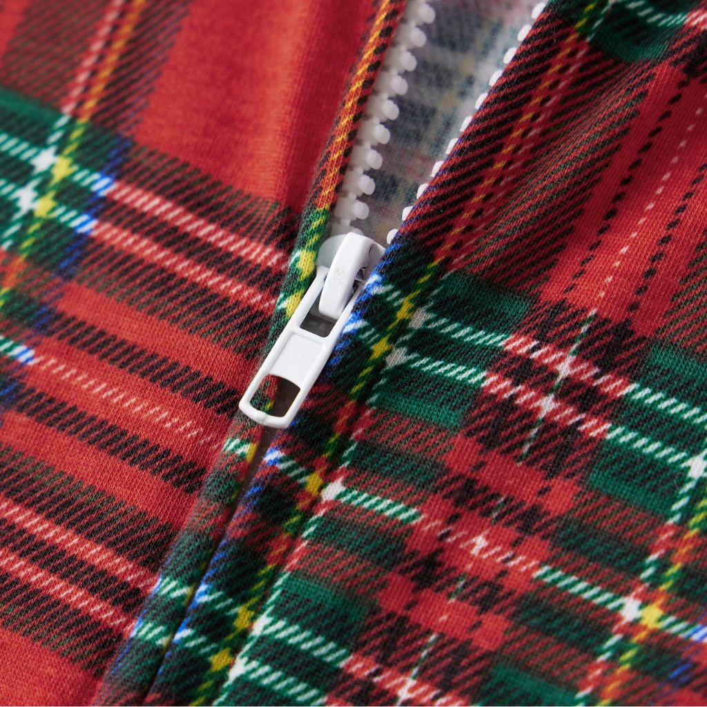 Fermeture éclair et tartan rouge vert et doré de la combinaison de Noël