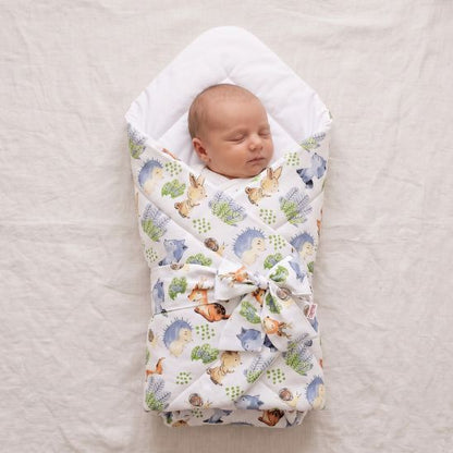 Bébé endormi emmailloté dans une couverture motif Petits Amis de la Forêt