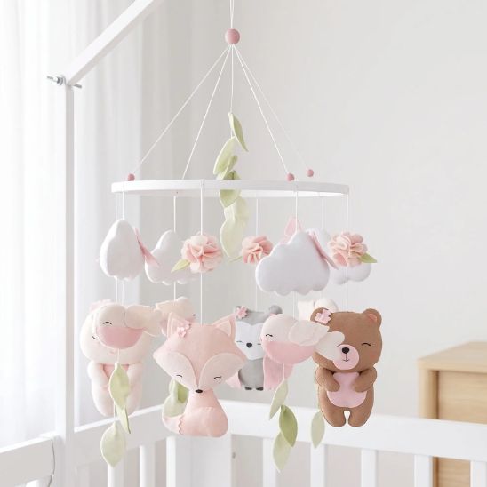 Mobile bébé fille installé au-dessus d’un lit bébé blanc