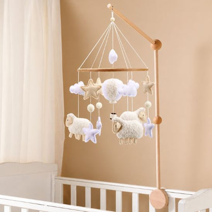 Mobile lit bébé moutons blancs bouclés installé sur bras en bois naturel au-dessus d'un lit à barreaux blanc étoiles beige et lavande nuages chambre bébé mixte