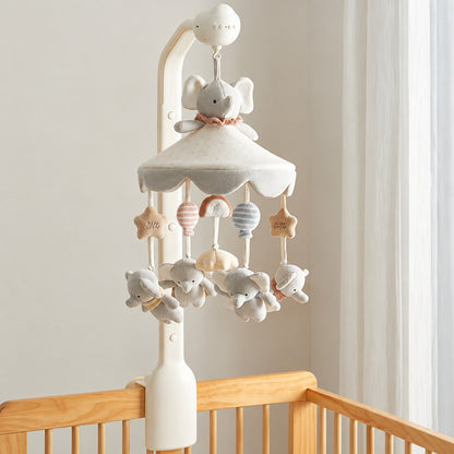 mobile musical bébé Bluetooth Mélodie modèle Trompette avec famille éléphant, montgolfières et arc-en-ciel sur un lit en bois