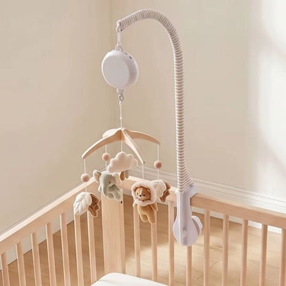 mobile musical bébé bohème avec bras rayé et boîte à musique Perle au-dessus d'un lit en bois