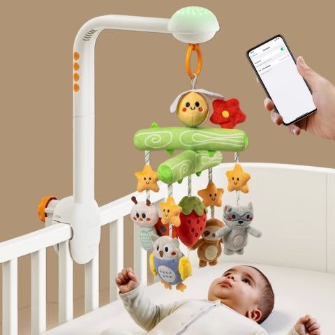  mobile musical pour bébé avec télécommande posé sur lit à barreaux