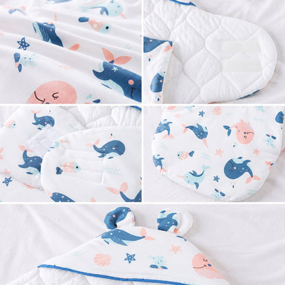 Détails du nid d'ange garçon : imprimé baleines, intérieur matelassé, scratch et oreilles
