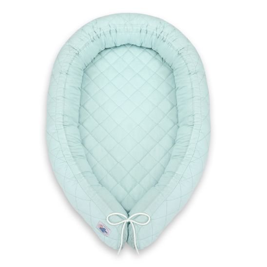 Réducteur de lit bébé menthe vu de dessus sur fond blanc