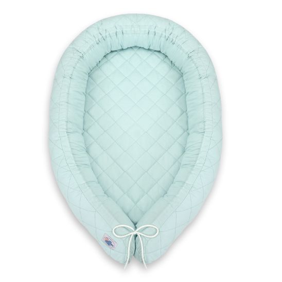 Réducteur de lit bébé menthe vu de dessus sur fond blanc