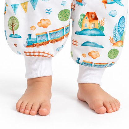 Zoom sur les pieds nus de bébé et les bords-côtes de la turbulette hiver motif Petit Train